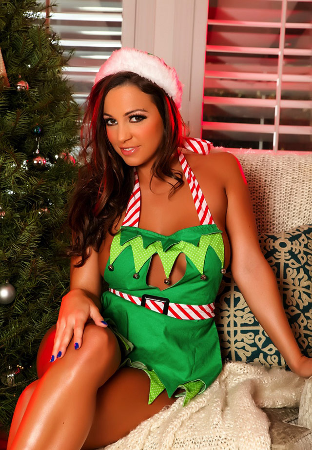 Sexy Christmas elf Abigail Mac naughty pictures by the tree.