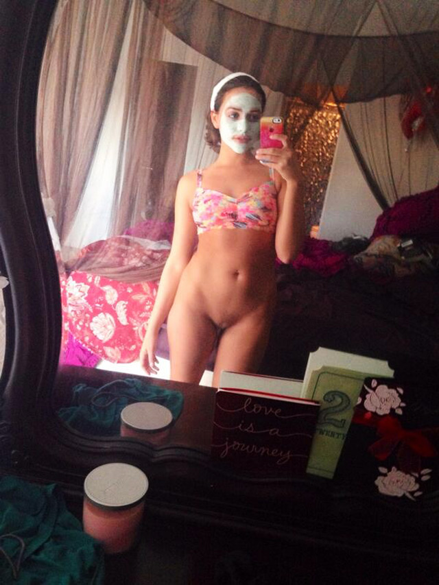 Brunette Mia Malkova selfie doing a facial mask.