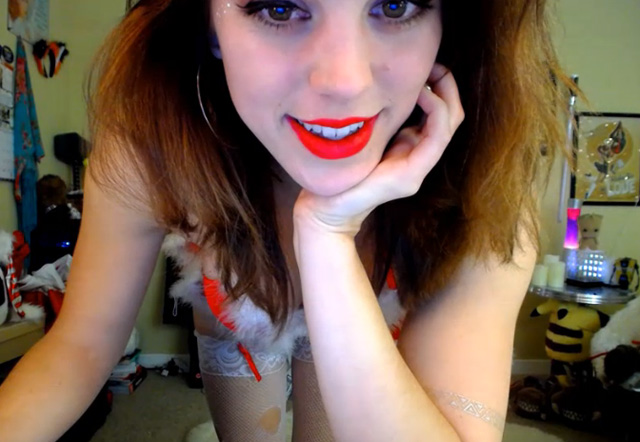 Horny cam girl Molly Christmas webcam babe flashing nice tits in Santa hat.